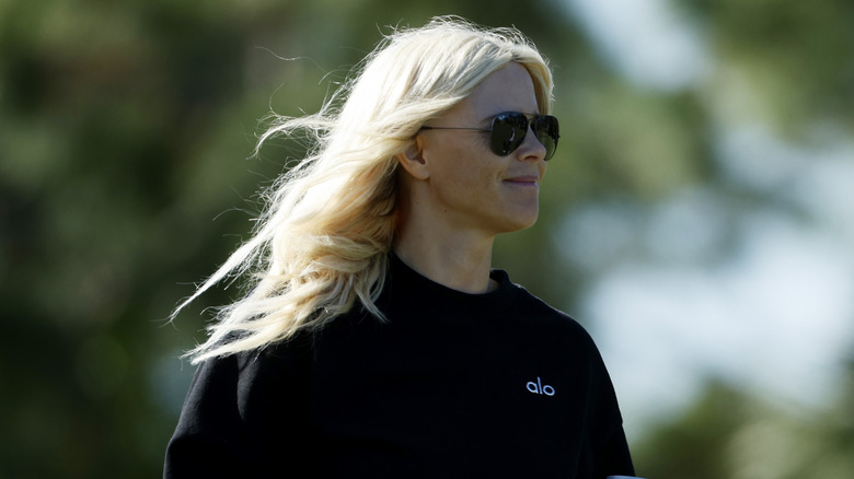 Elin Nordegren wearing dark shades at a golf tournament