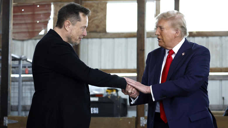 Elon Musk shaking hands with Donald Trump