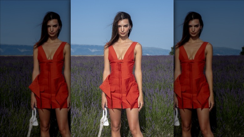 Emily Ratajkowski posing in tomato red dress