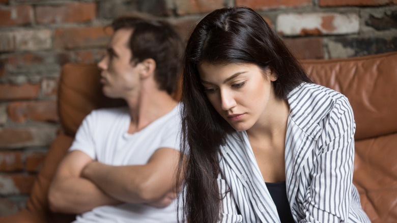 A boyfriend and girlfriend talk with each other.