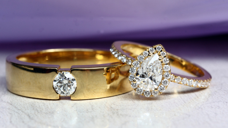 pear shaped halo engagement ring with gold wedding band