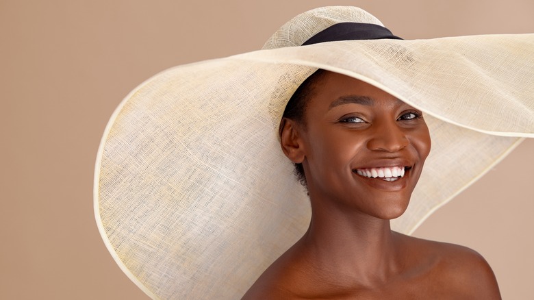 black woman smiling in large hat