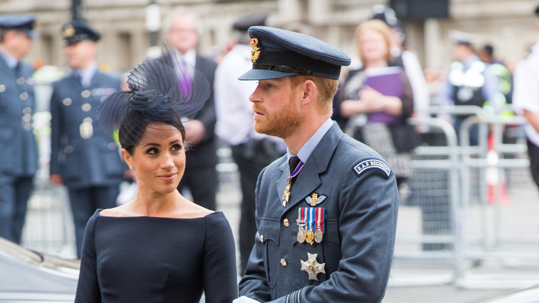 Prince Harry in uniform next to Meghan Markle