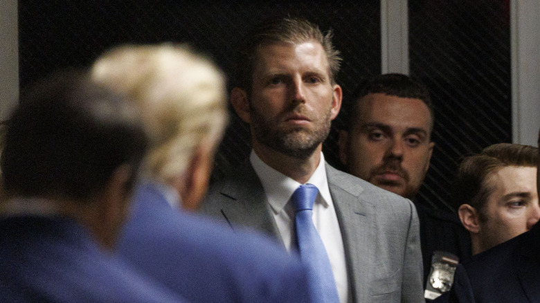 Eric Trump looking at his father outside a New York courthouse