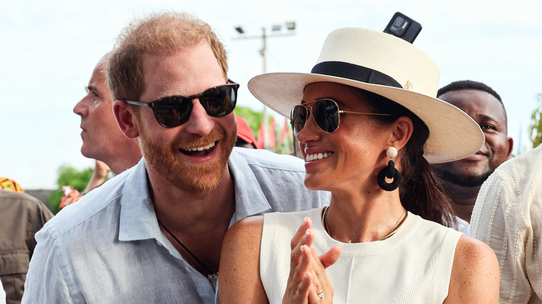 Prince Harry and Meghan Markle laughing together at appearance