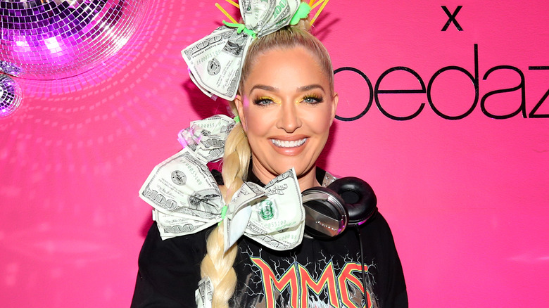 Erika Jayne Girardi deejays with money accessories