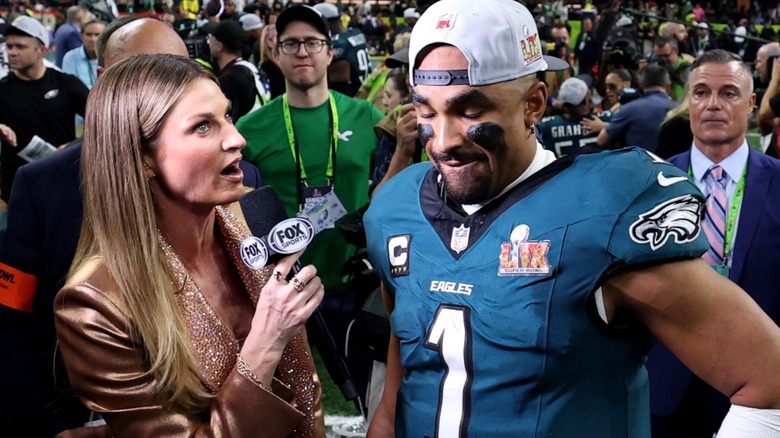 Erin Andrews interviewing at the Super Bowl in gold suit