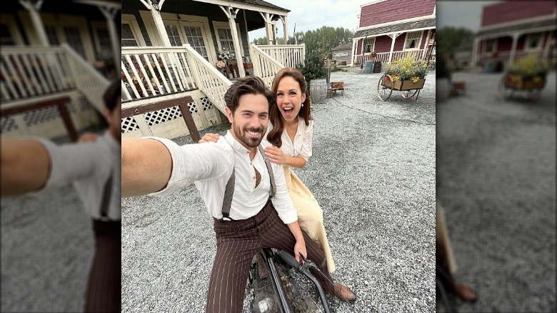 Chris McNally and Erin Krakow posing on set