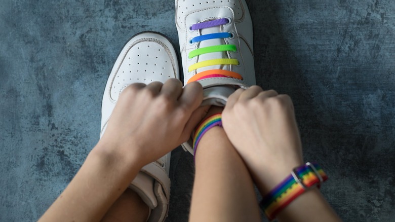 Person adjusting shoe laces