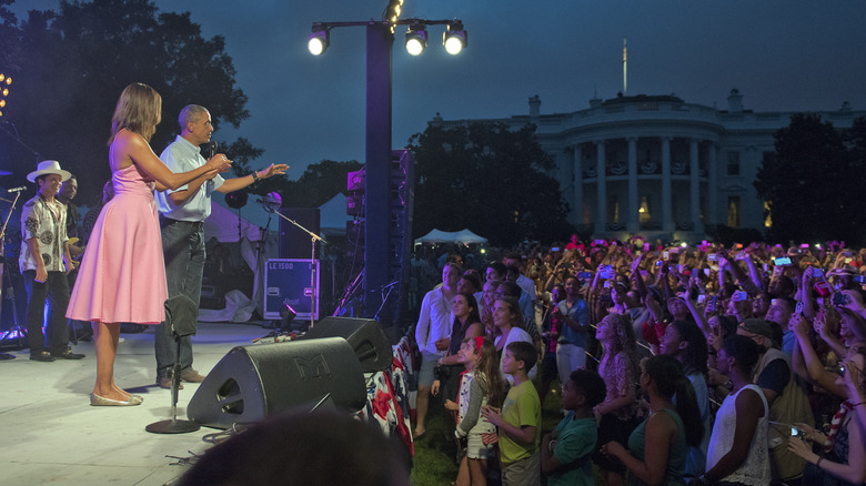 Michelle and Barack Obama address a crowd at a White House evemt