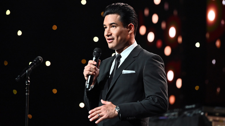 Mario Lopez speaking into a microphone