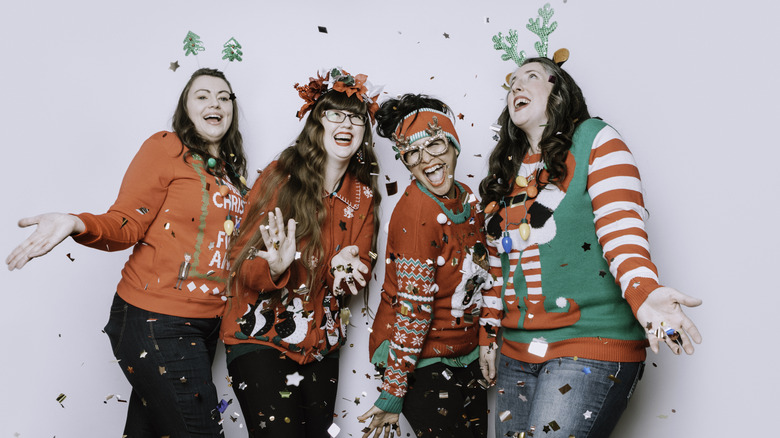 Happy women in ugly Christmas sweaters