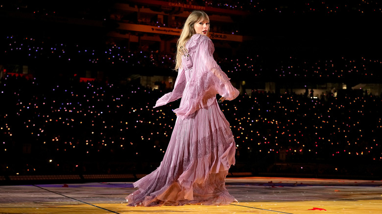 Taylor Swift on stage in long purple dress