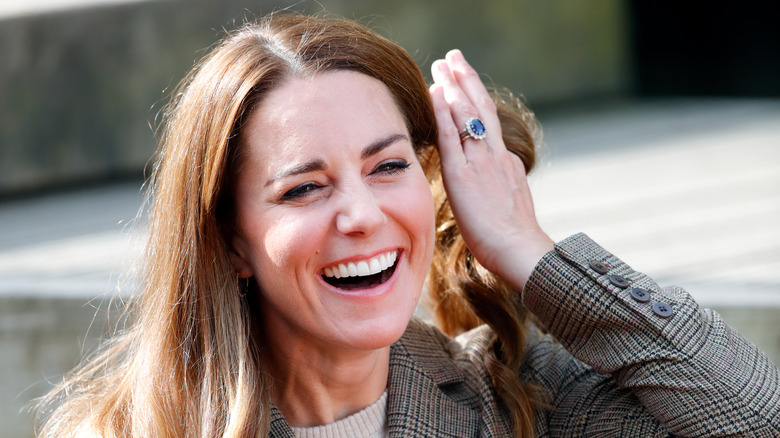 Princess Catherine smiles while flipping hair 