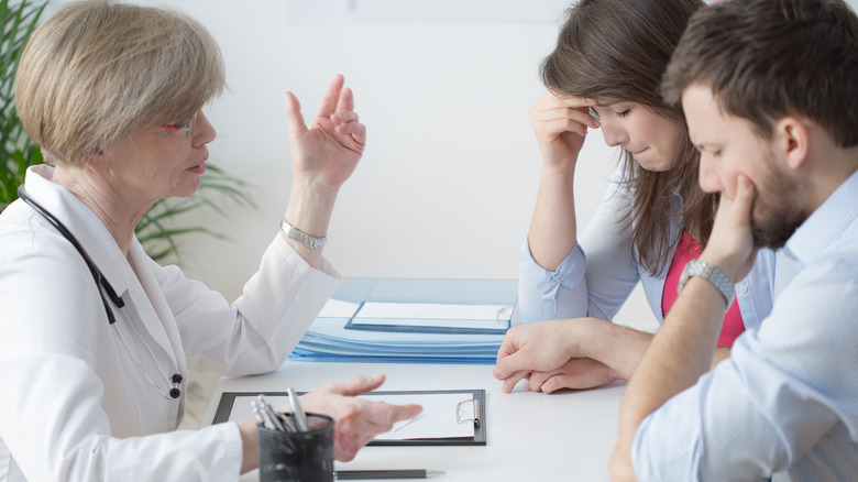 Couple speaking to a doctor