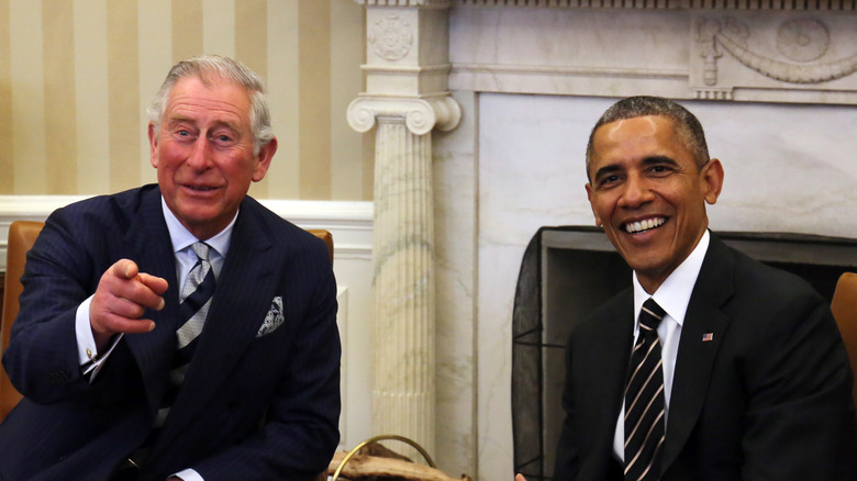 Prince Charles pointing and Barack Obama smiling