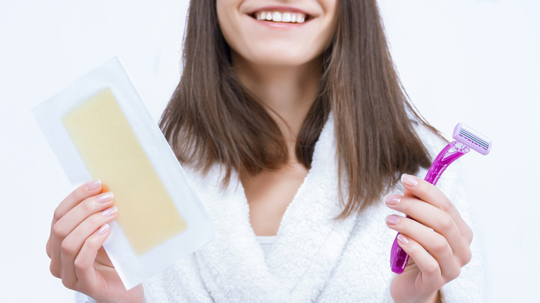 Woman holding hair removing products