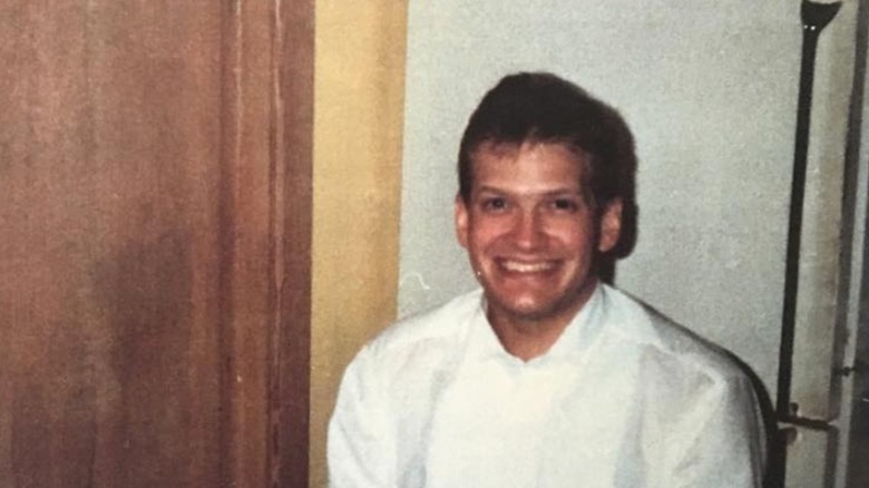 Drew Carey sitting in waiter uniform in the 1980s