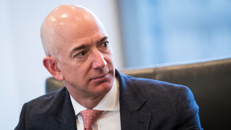 Jeff Bezos looking sideways at Donald Trump