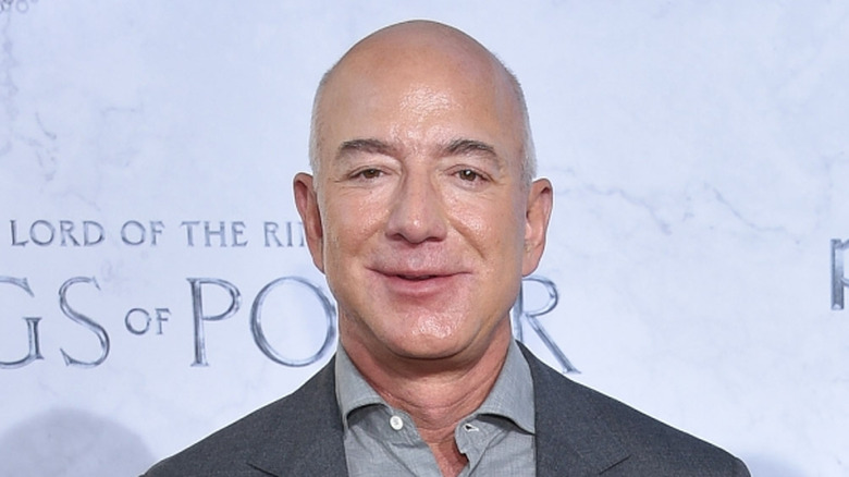 Jeff Bezos smiling for photo in gray suit