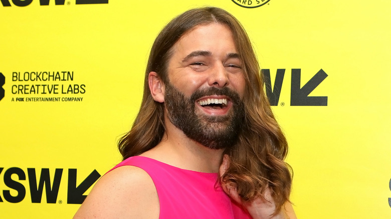 Jonathan Van Ness tousles hair at event