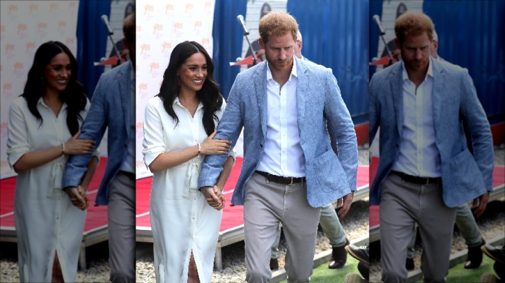 Prince Harry holding Meghan Markle's hand in Johannesburg