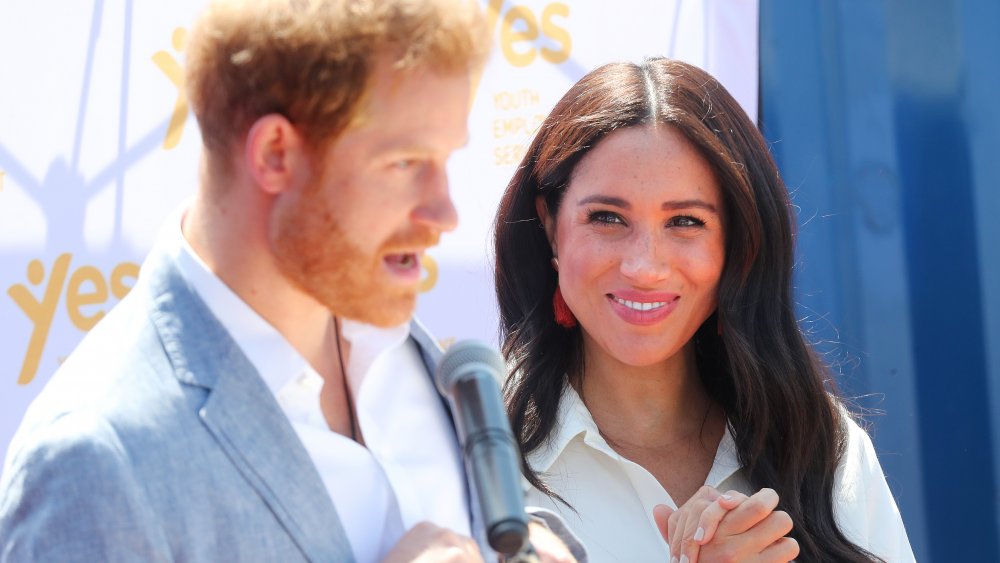 Meghan Markle smiling at husband Prince Harry