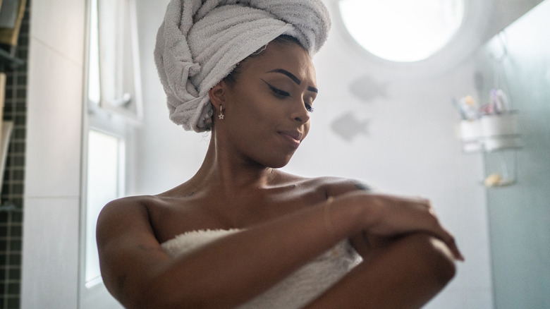 woman moisturizing after shower