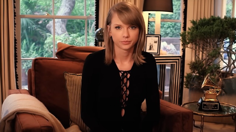 Taylor Swift sitting in an armchair