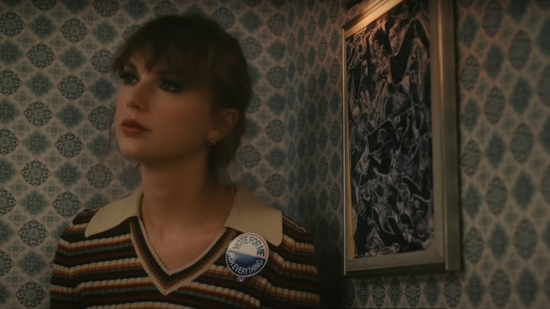 Taylor Swift wearing a "vote for me" pin