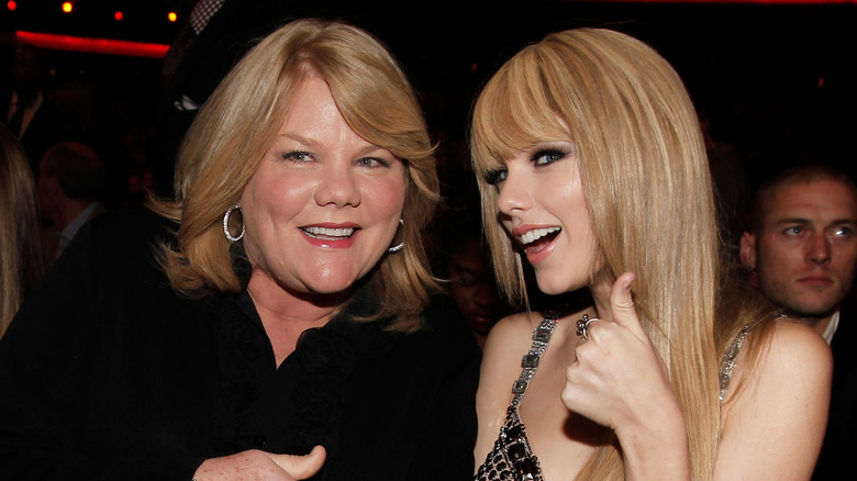 Taylor Swift and Andrea Swift posing together in an audience 