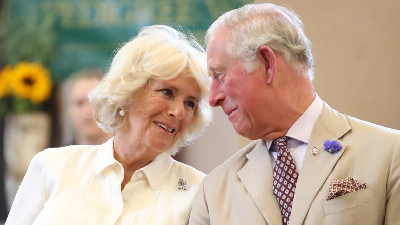 King Charles and Queen Camilla smiling 