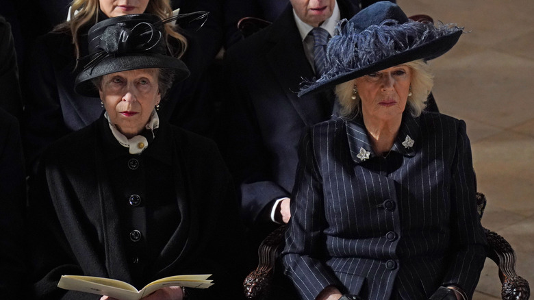 Princess Anne and Queen Camilla looking solemn 