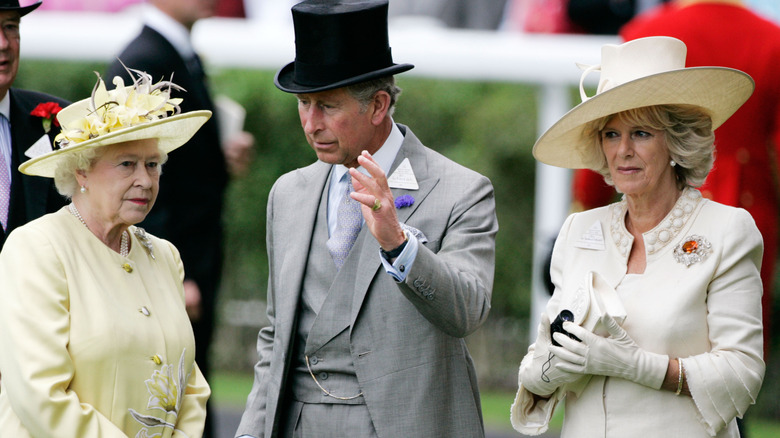 Queen Elizabeth II talking to King Charles and Queen Camilla