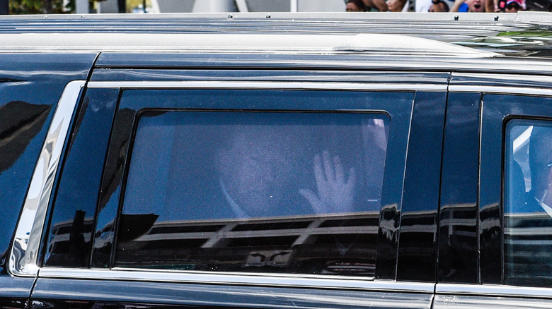 Donald Trump waving from inside car