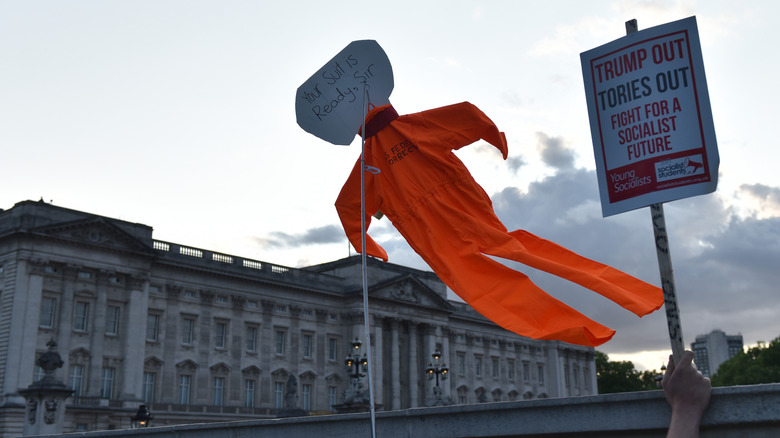 Protester holding a placard with orange suit