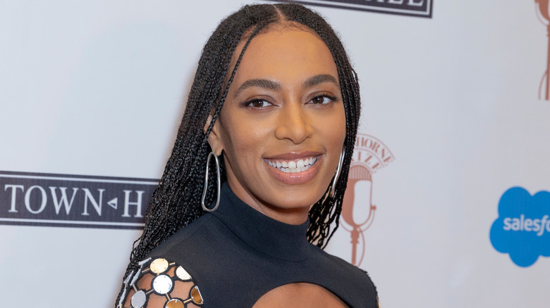 Solange Knowles smiles while wearing black