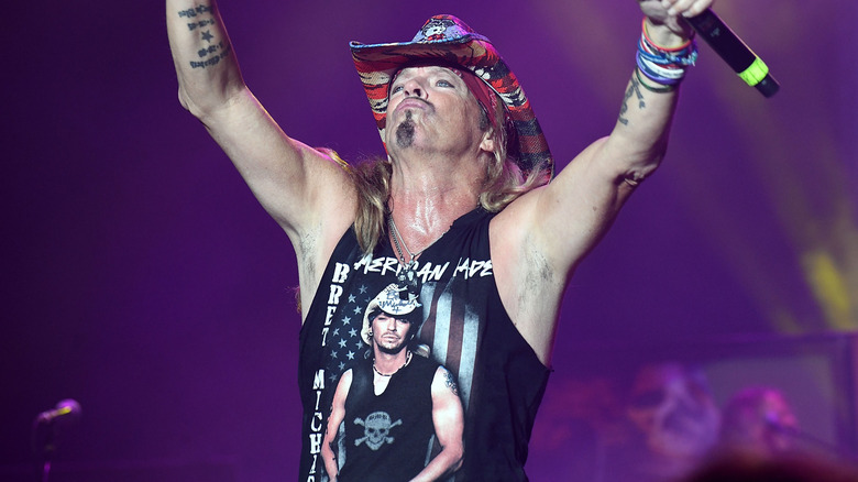 Bret Michaels sleeveless shirt cowboy hat arms raised