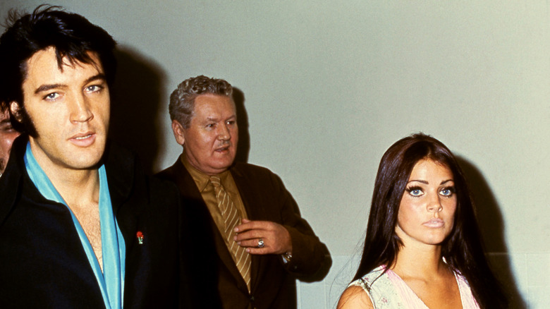 Priscilla Presley and Elvis Presley walking