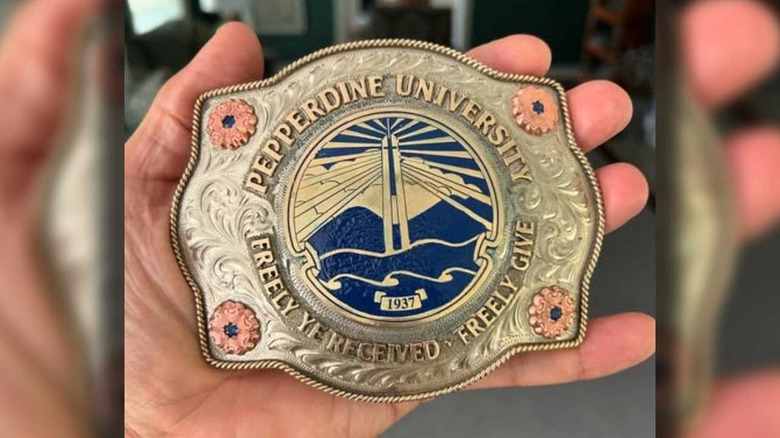 Will Cain shows off a Pepperdine belt buckle he was given as a gift