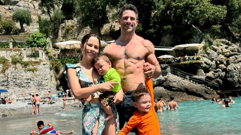 Brant Daugherty and his family posing in the water