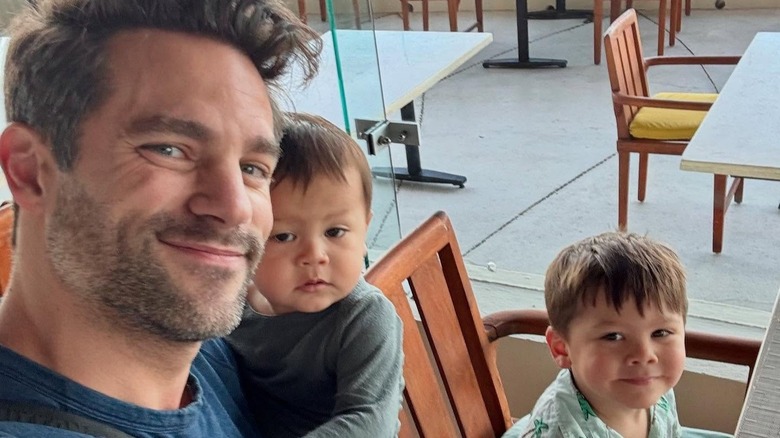 Brant Daugherty smiling with his kids