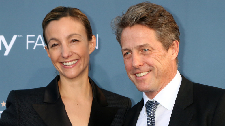 Hugh Grant and Anna Eberstein smiling red carpet in LA, 2016