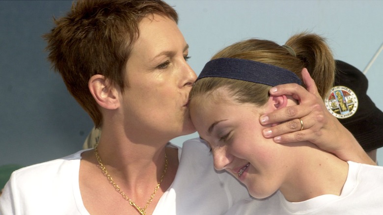 Jamie Lee Curtis kissing Annie Guest on the forehead