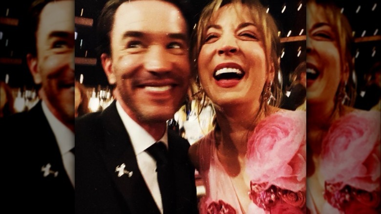 Tom Pelphrey and Kaley Cuoco laughing in burry image