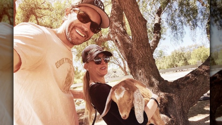 Kaley Cuoco and Tom Pelphrey posing with goat