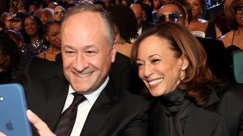 Doug Emhoff and Former Vice President Kamala Harris pose for a selfie photo during the 56th NAACP Image Awards at Pasadena Civic Auditorium on February 22, 2025 in Pasadena, California.