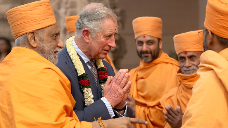 King Charles praying to priests in India 