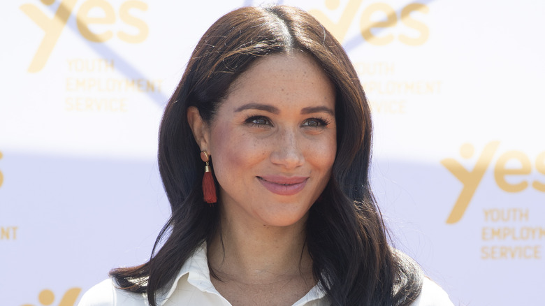 Meghan Markle smiles at an event