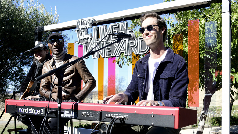 Sean Douglas singing and playing keyboard on stage